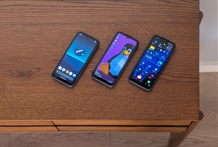 Three phones side-by-side: one running Android, one running Debian, and one running Windows 11